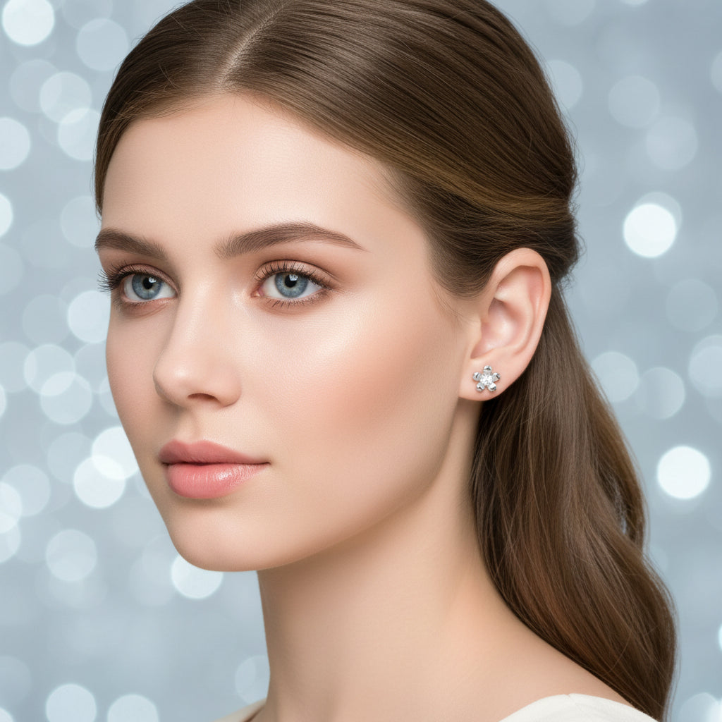 Silver Zirconia Flower Earrings worn on an ear with a plain background