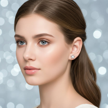 Silver Zirconia Flower Earrings worn on an ear with a plain background