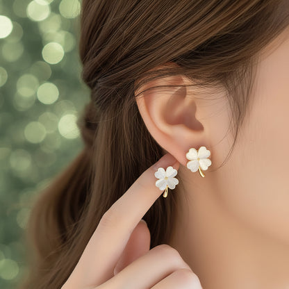 Opalescent Clover Earrings being worn and held up to an ear.