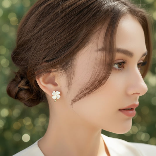 Close-up of a person wearing an Opalescent Clover Earring with a blurred background