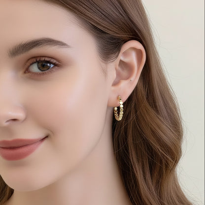 Person wearing a Gold Bead Accent Hoop Earring with a neutral background