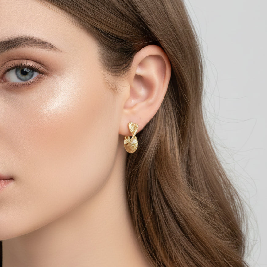 Gold Woven Twist Hoop Earring being worn by a woman