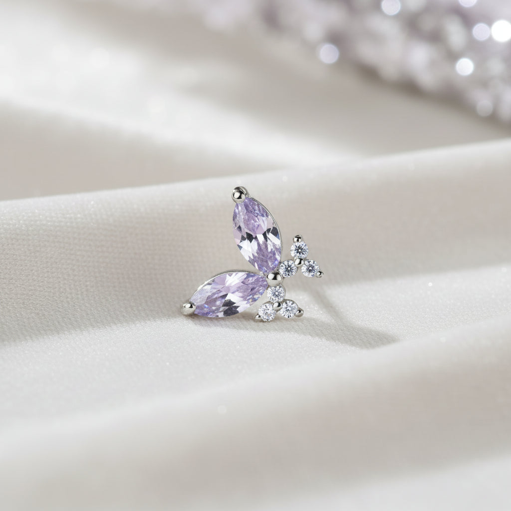 Twilight Lavender Butterfly Earrings with purple gemstones on a soft fabric background