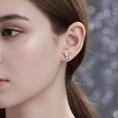 Close-up of a woman wearing Twilight Lavender Butterfly Earrings with a blurred background