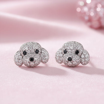 Pavé Puppy Earrings with sparkling details on a pink background
