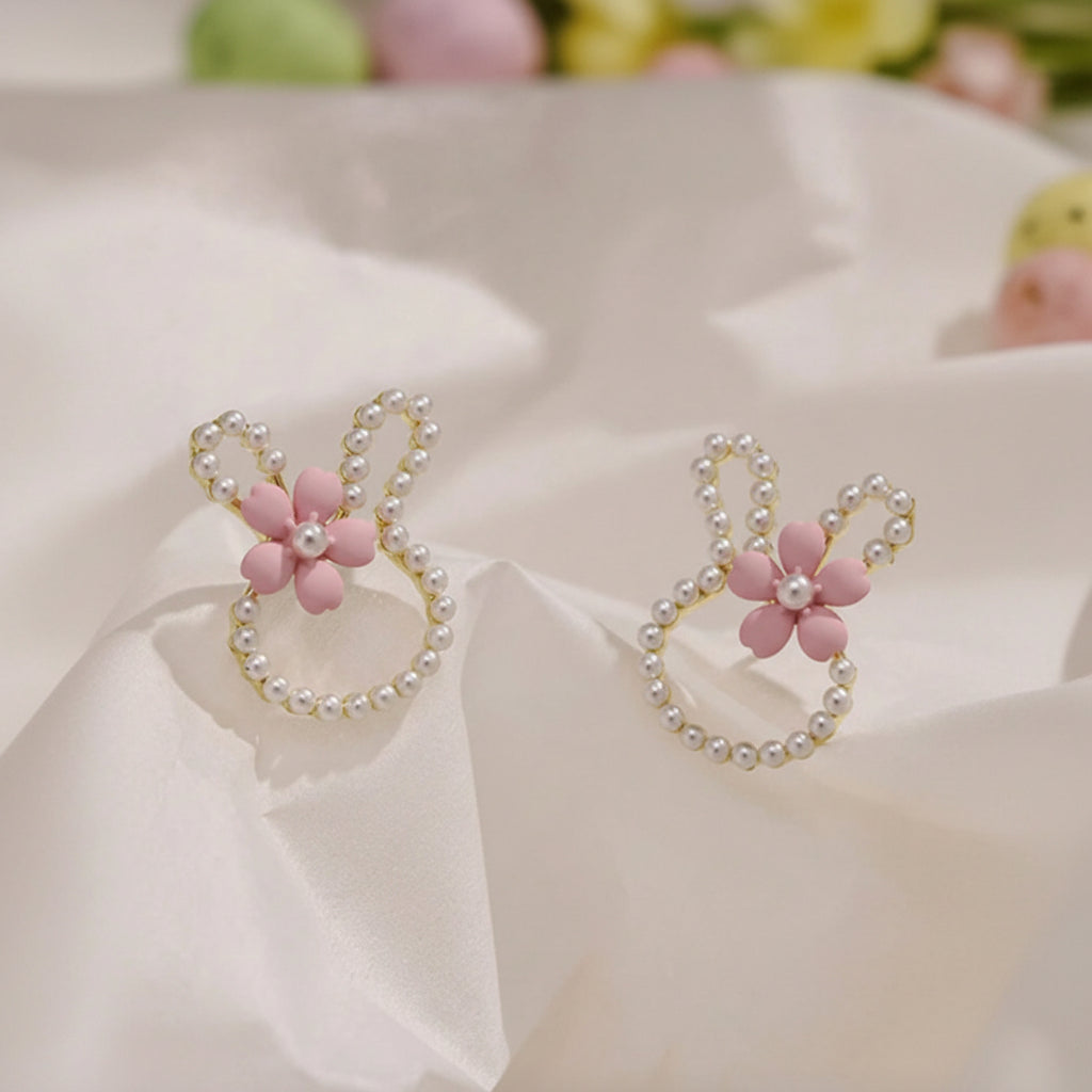 Pearl Bunny Blossom Earrings with pink floral and pearl designs on a light background