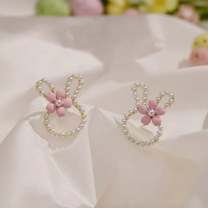 Pearl Bunny Blossom Earrings with pink floral and pearl designs on a light background