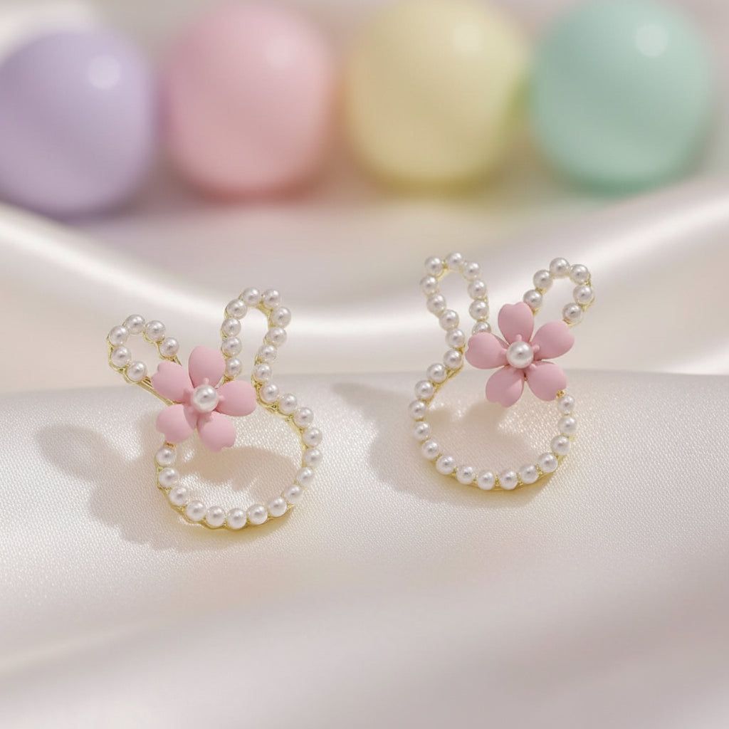 Pearl Bunny Blossom Earrings with pink floral ends and pearl accents on a light background
