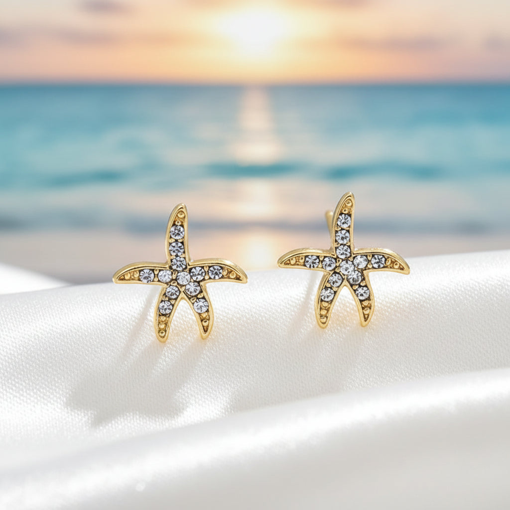Pavé Starfish Earrings on a beach at sunset