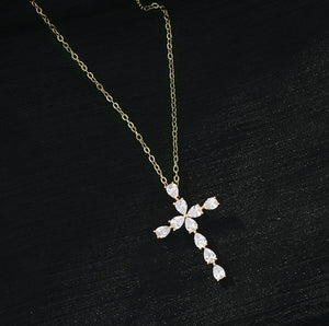 Close-up of the zirconia stones on the gold cross pendant, highlighting its radiant sparkle.