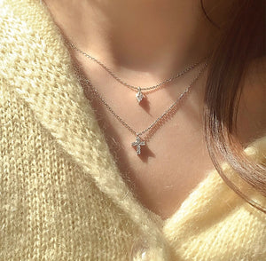 Close-up of layered Mini Cross Rhinestone Necklace styled with different outfits, demonstrating its versatility and elegant appeal.