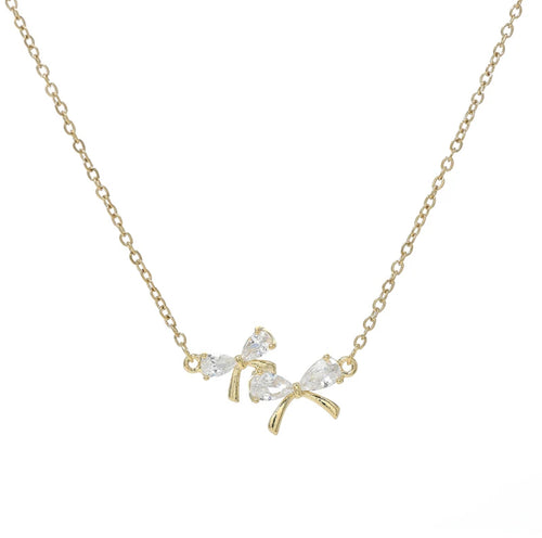 Zircon Bow Necklace, plain white background.