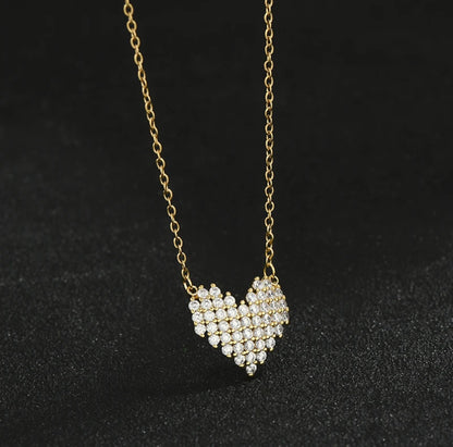 Rhinestone Heart Necklace on a gold chain against a black background