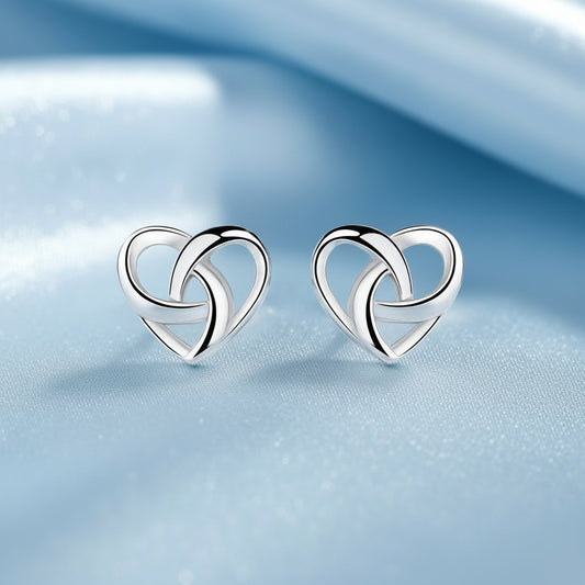 Pair of silver Infinity Knot Heart Earrings on a soft background