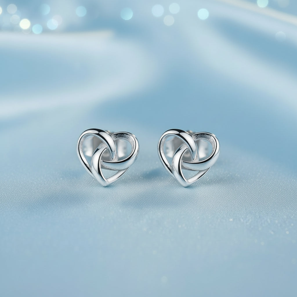 Infinity Knot Heart Earrings on a soft blue background
