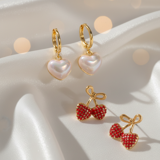 Iridescent Heart & Gold Bow Strawberry Earrings Bundle on a light pink fabric background