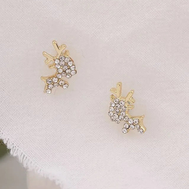 Gold Zircon Reindeer Earrings on a light fabric background