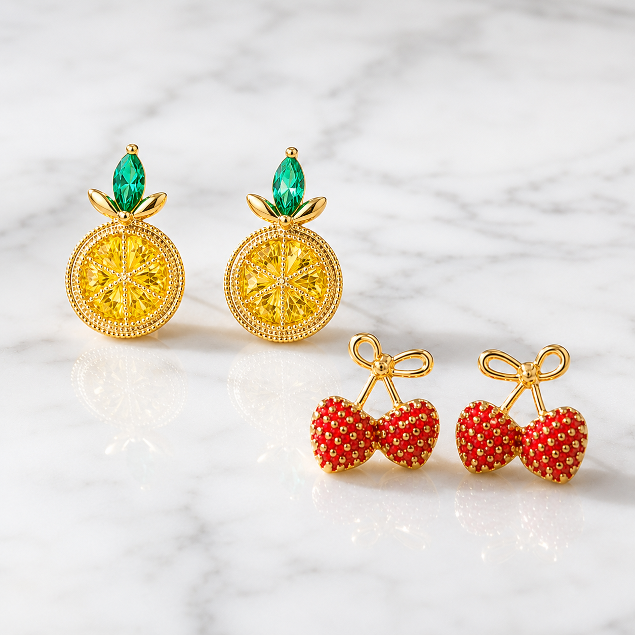 Lemon Slice & Gold Bow Strawberry Earring Set on a marble surface