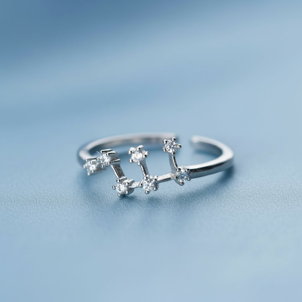 Silver Leo ring with star design on a light blue background