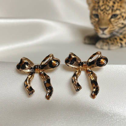 Leopard Print Bow Earrings on white background with a leopard cub