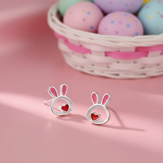 Silver Little Love Bunny Earrings with pink ears and red hearts on a pink background with Easter eggs.