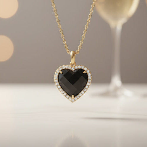 Midnight Black Heart Necklace on a neutral background