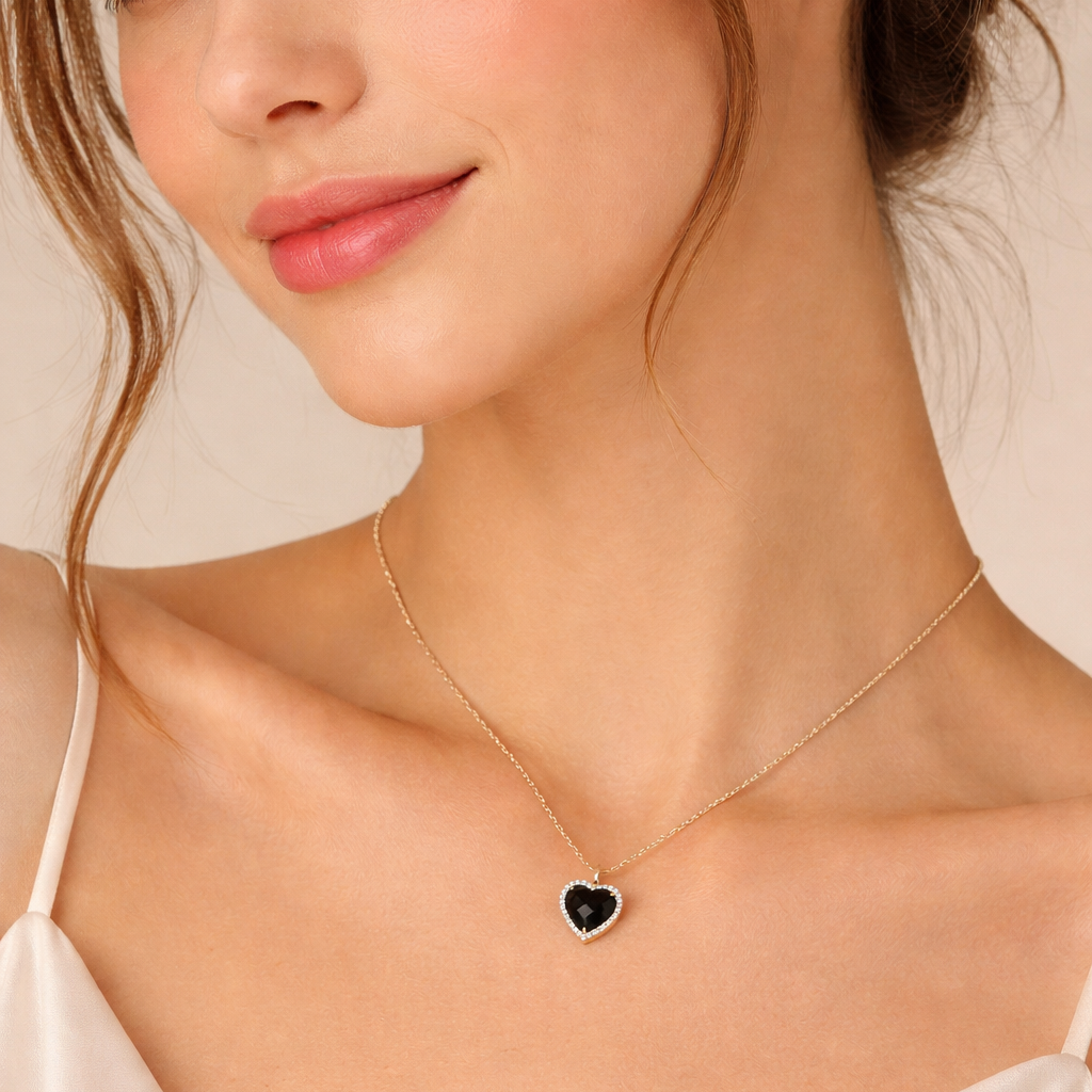 Woman wearing a Midnight Black Heart Necklace against a neutral background