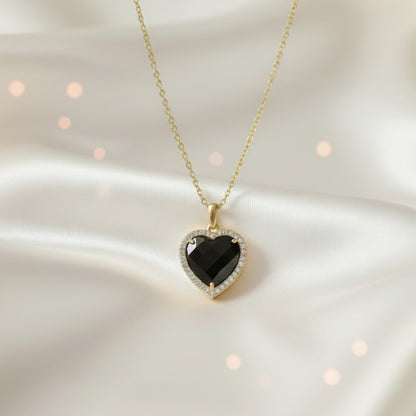 Midnight Black Heart Necklace against a soft background