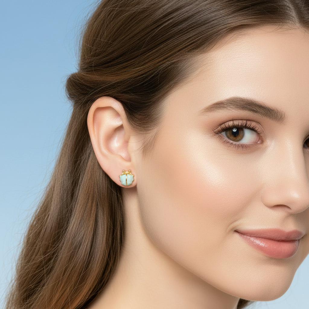 Woman wearing Mini Baby Blue Ladybug Earrings