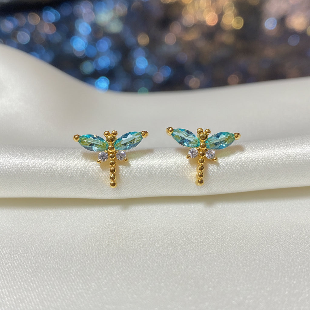 Mini Gemstone Dragonfly Earrings on a round white card with a dark background