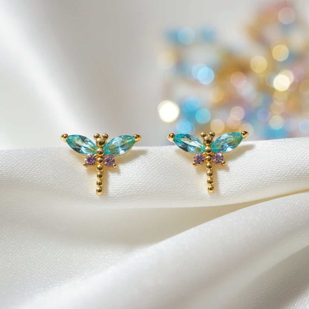 Mini Gemstone Dragonfly Earrings on a white card with a wooden surface background