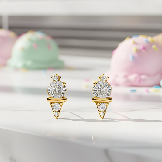 Mini Gold Ice Cream CZ Earrings with clear gemstones on a white surface with colorful pastries in the background