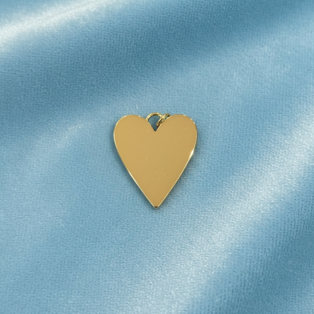 Mother-of-Pearl Heart Charm on a light blue satin background (back view)