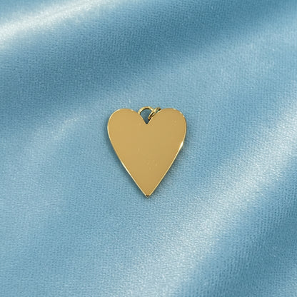 Mother-of-Pearl Heart Charm on a light blue satin background (back view)