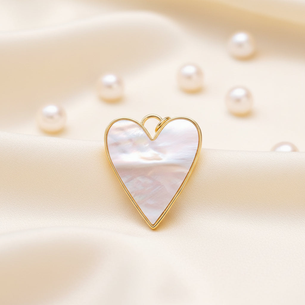 Mother-of-Pearl Heart Charm with gold frame and mother-of-pearl center on a soft beige background.