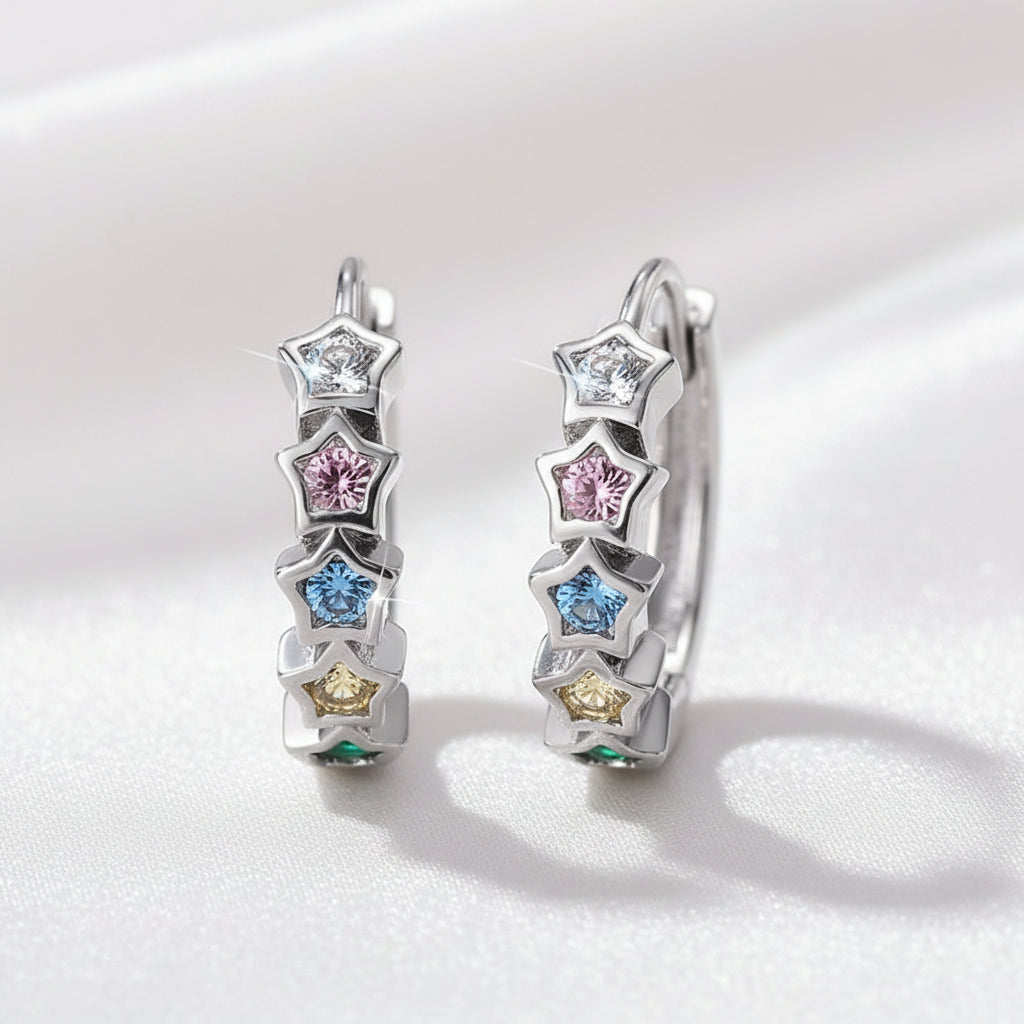 Multicolor Star Hoop Earrings with star-shaped gemstones on a light pink background