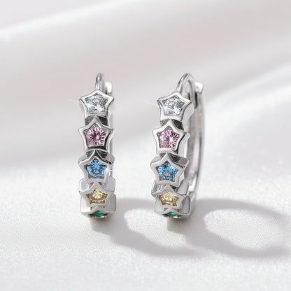 Multicolor Star Hoop Earrings with star-shaped gemstones on a light pink background