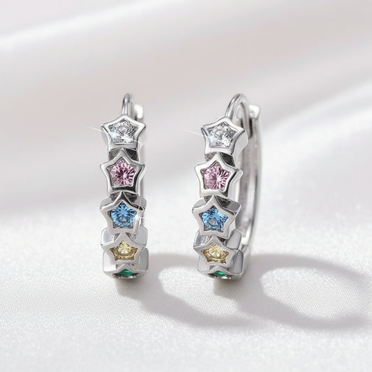 Multicolor Star Hoop Earrings with star-shaped gemstones on a light pink background