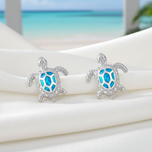 Ocean Blue Sea Turtle Earrings on a light blue background.