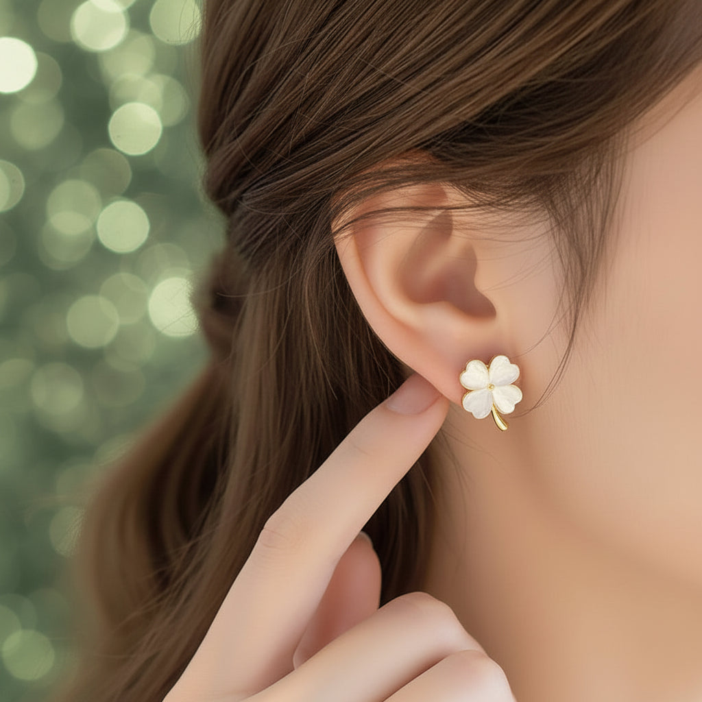 Opalescent Clover Earrings being worn and held up to an ear.