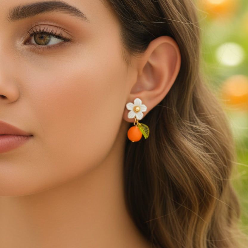 Close-up of a woman wearing a Orange Blossom Dangle Earring