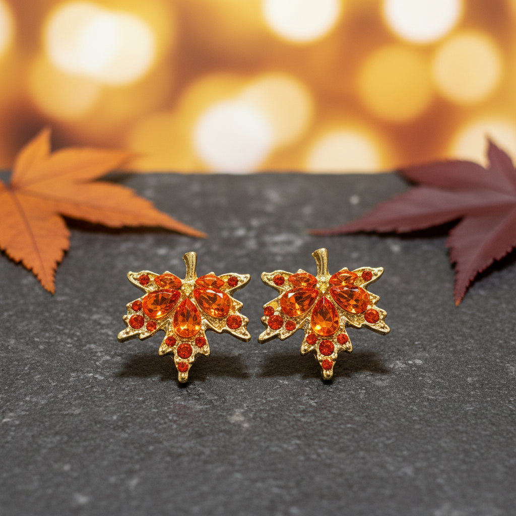 Orange Crystal Maple Leaf Earrings on stone