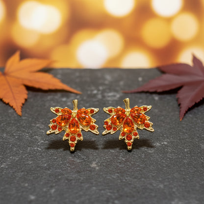 Orange Crystal Maple Leaf Earrings on stone