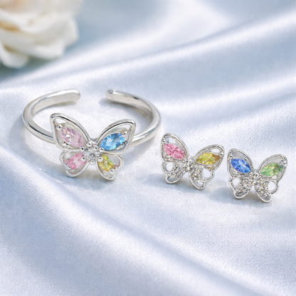 Pastel Butterfly Adjustable Ring & Earrings Bundle on a satin surface