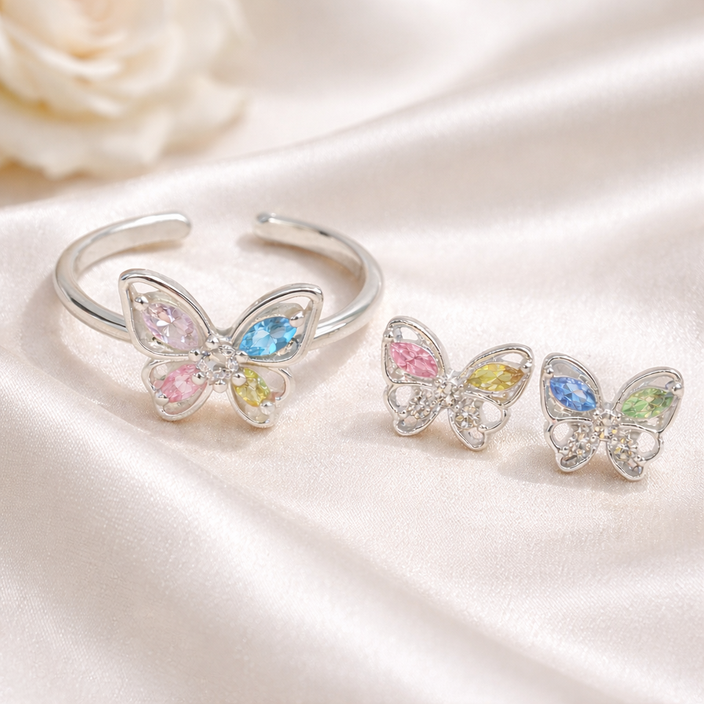 Pastel Butterfly Adjustable Ring & Earrings Bundle on a white satin surface