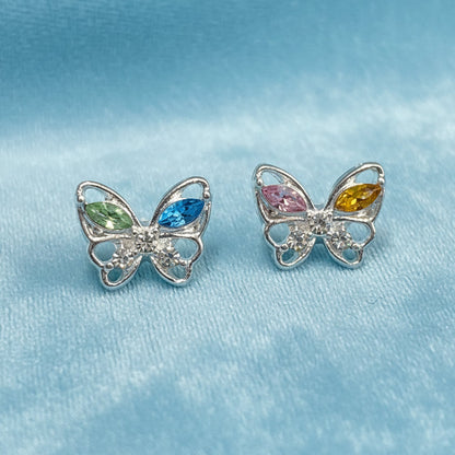 Pastel Crystal Butterfly Earrings with colorful gemstones on a light blue fabric
