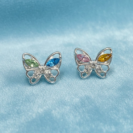 Pastel Crystal Butterfly Earrings with colorful gemstones on a light blue fabric