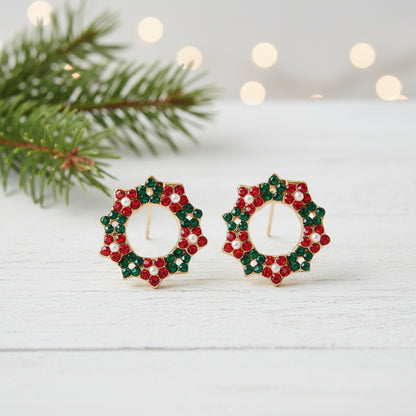 Pavé Christmas Wreath Earrings with a blurred festive background.