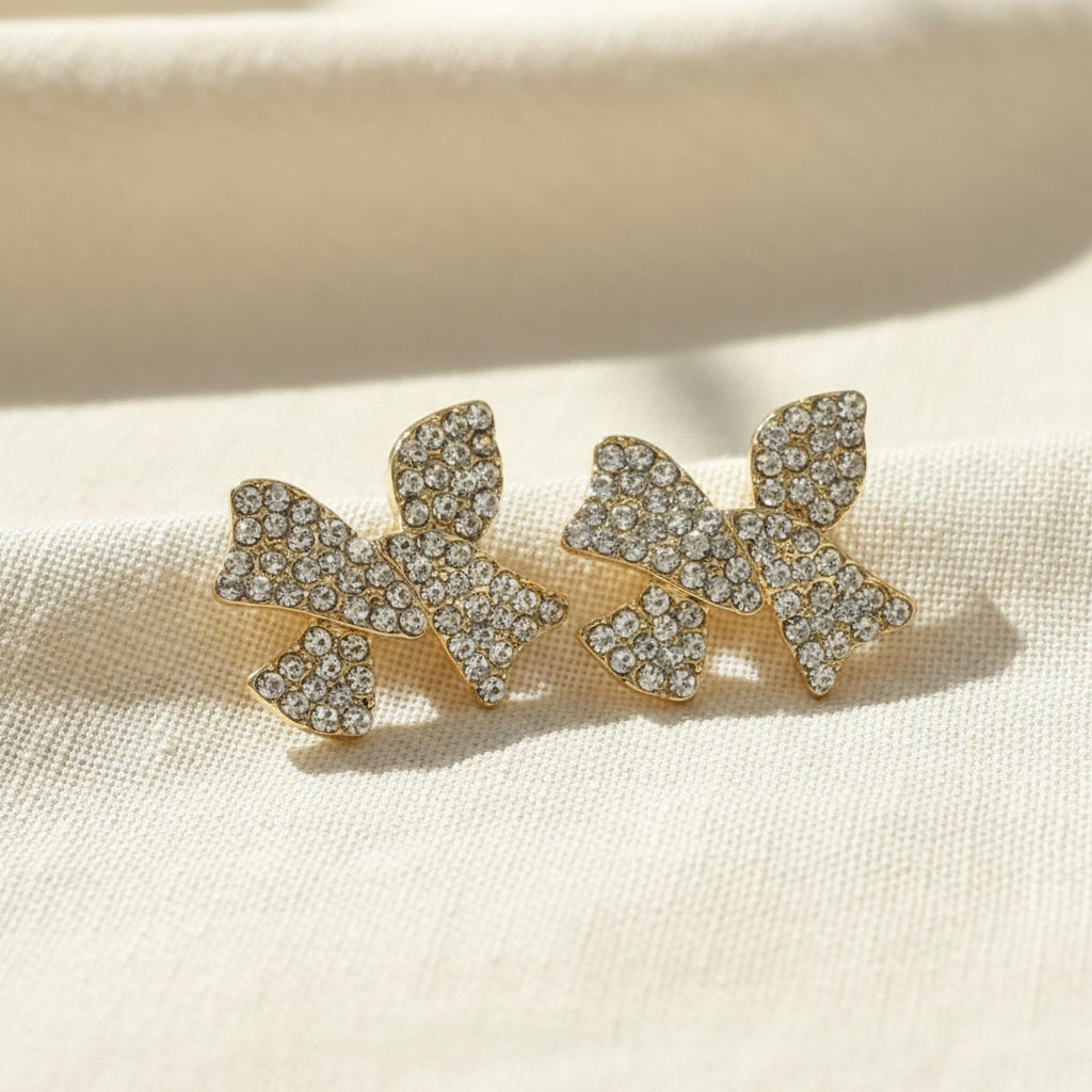 Pavé Crystal Bow Earrings on linen