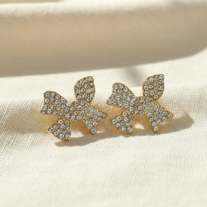 Pavé Crystal Bow Earrings on linen